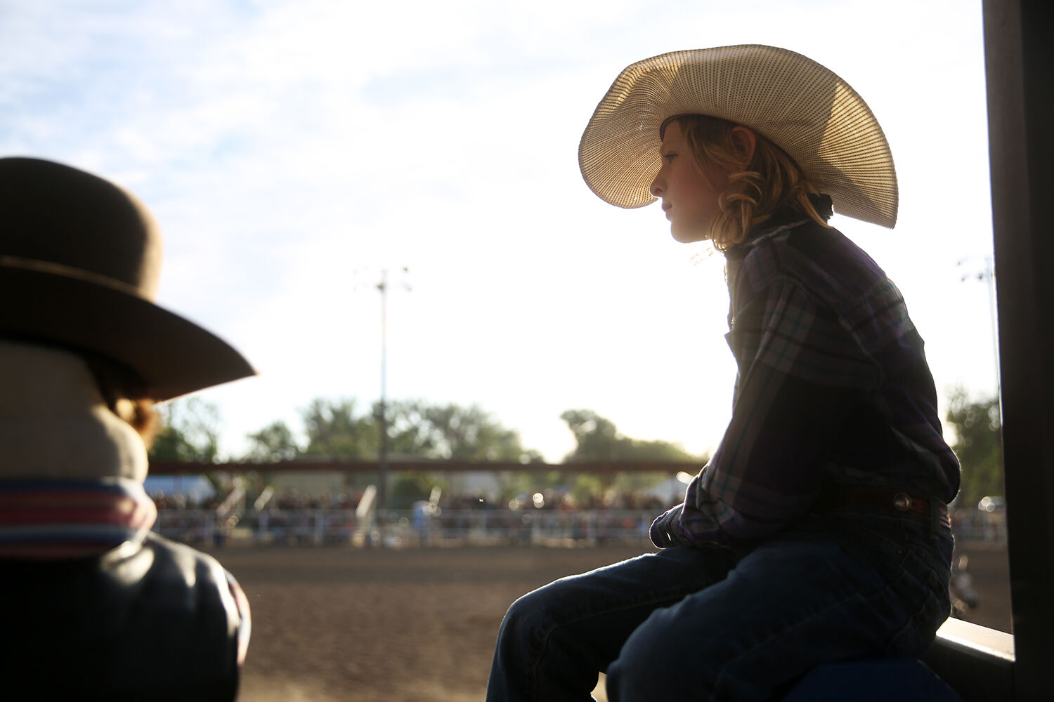 Tyke Coffman, 9, sits on his perch above a bucking shoot